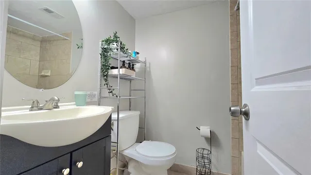 a bedroom with a bed and a flat tv screen