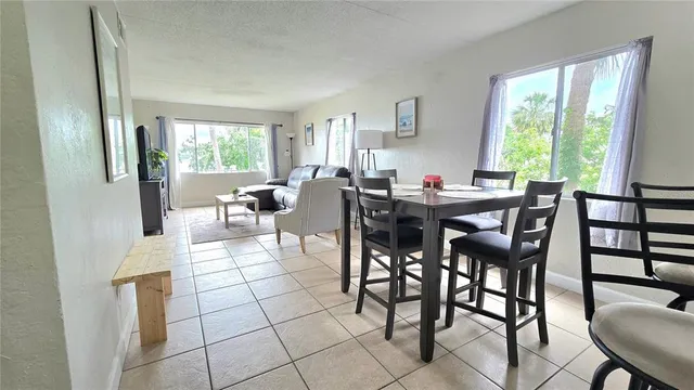 a view of a dining room with furniture and a window