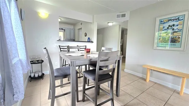 a view of a dining room with furniture and a chandelier