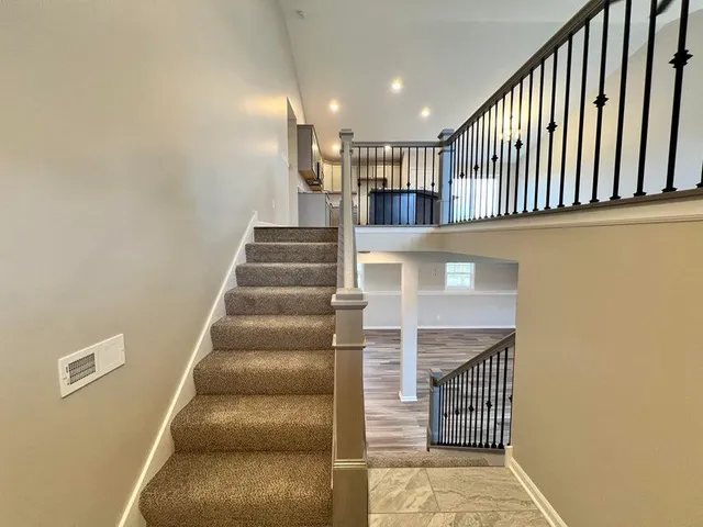 a view of entryway and hall with wooden floor