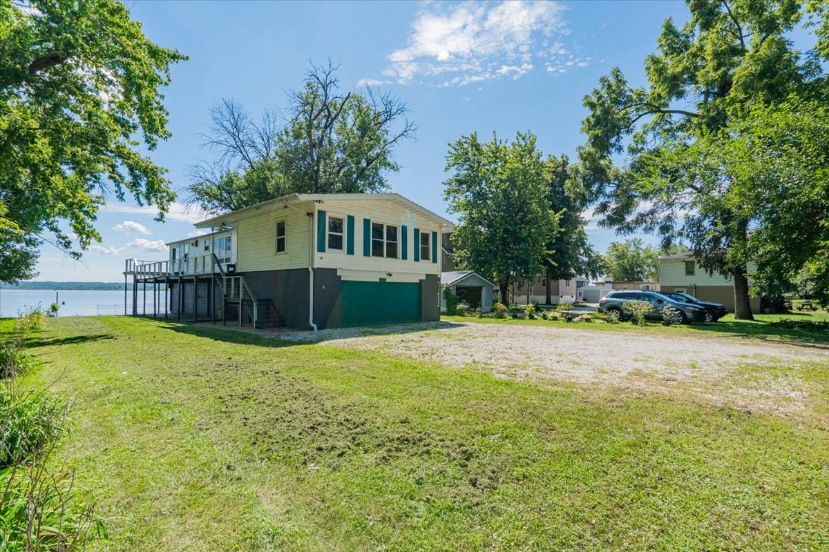 16032 North Portage Street Chillicothe, IL 61523 - Photo 2 of 34 a yellow house in middle of the garden