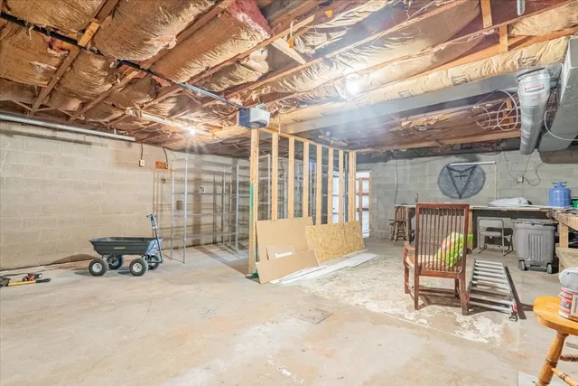 a view of patio with a table and chairs and a barbeque