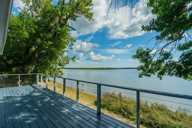 a view of balcony with wooden floor and fence