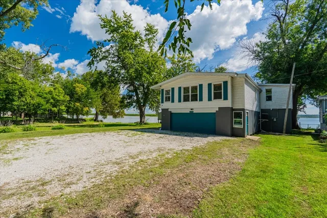 a front view of a house with a garden and yard