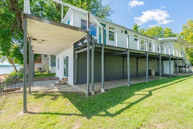 a view of a house with a backyard and a patio