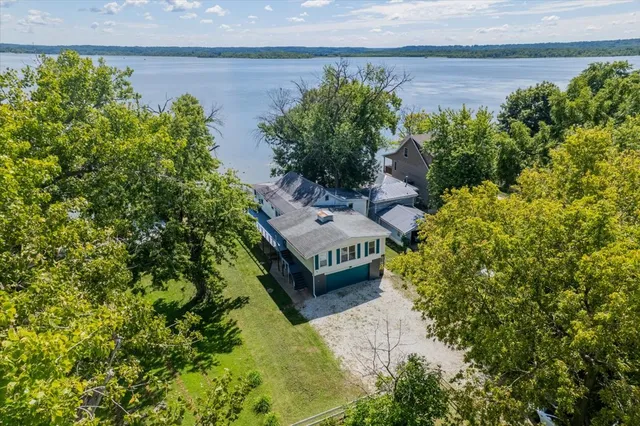 an aerial view of a house with a yard basket ball court and outdoor seating
