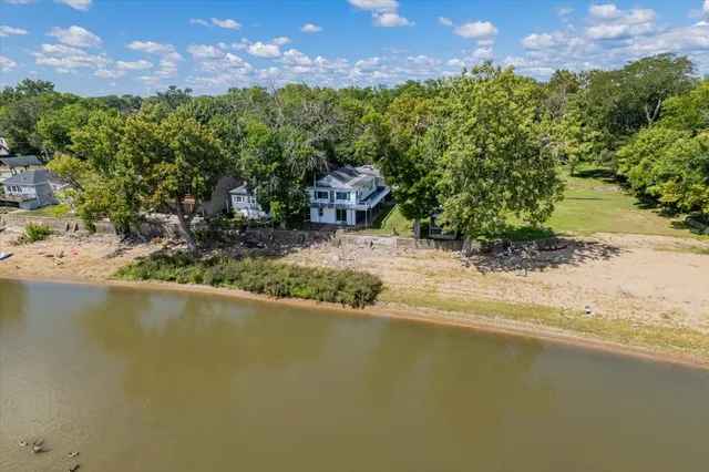 a view of a lake with a house in the background