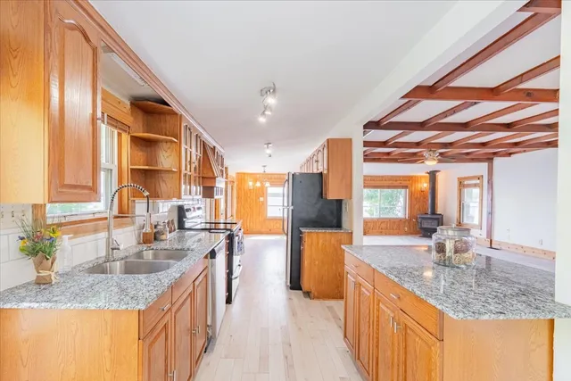 a kitchen with stainless steel appliances granite countertop a sink and a counter space