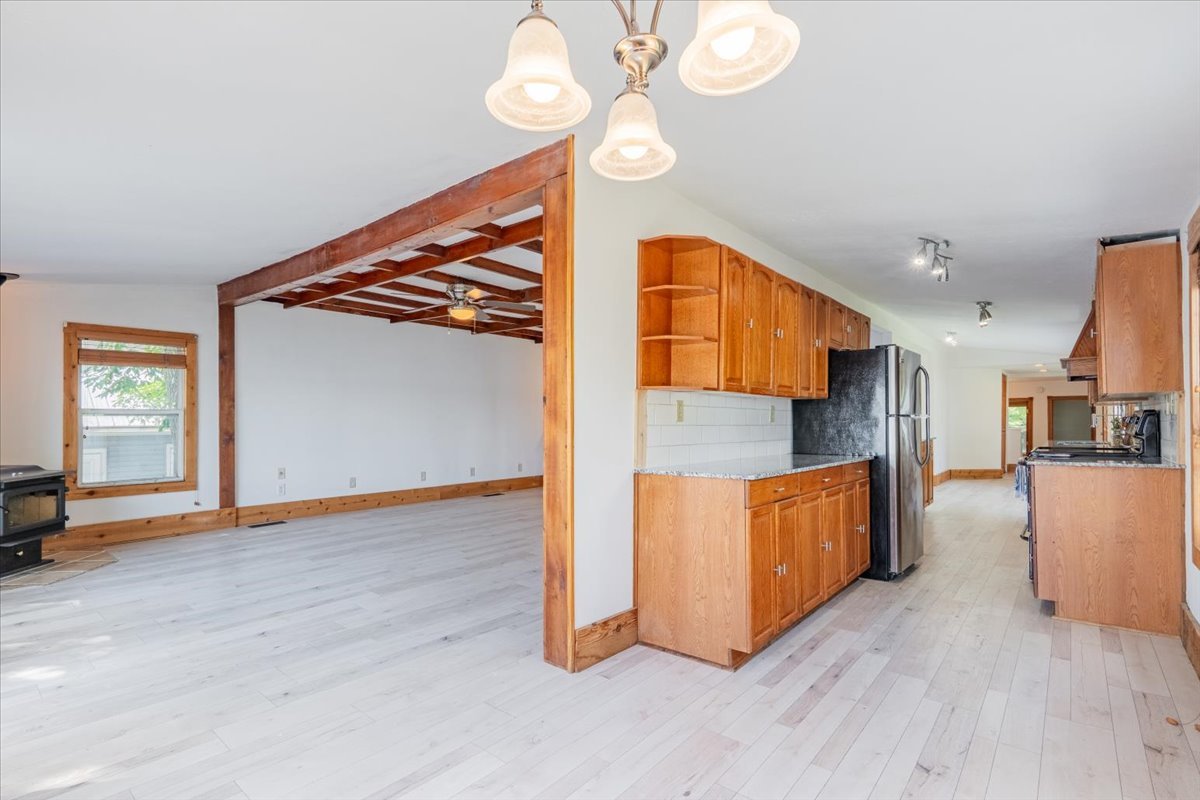 16032 North Portage Street Chillicothe, IL 61523 - Photo 10 of 34 a view of a kitchen with furniture and a ceiling fan