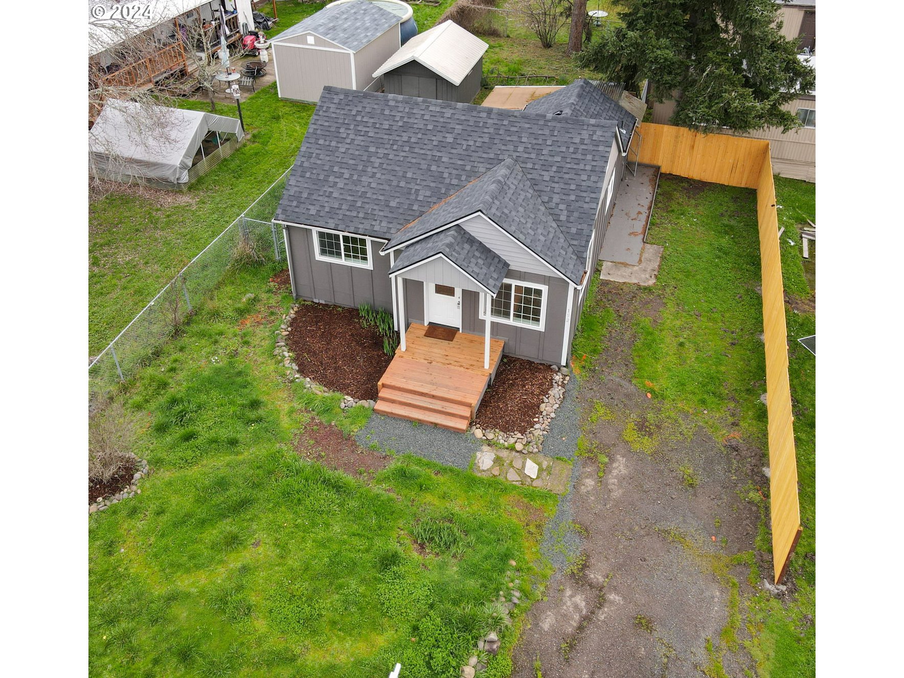 a aerial view of a house with a yard table and chairs