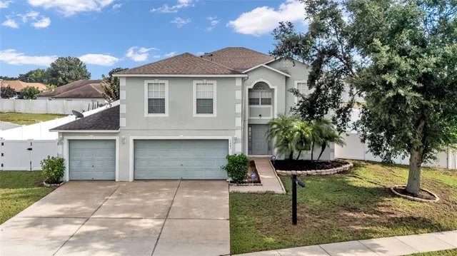 a front view of a house with a yard and garage