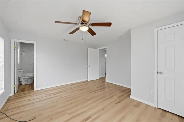 a view of an empty room and wooden floor