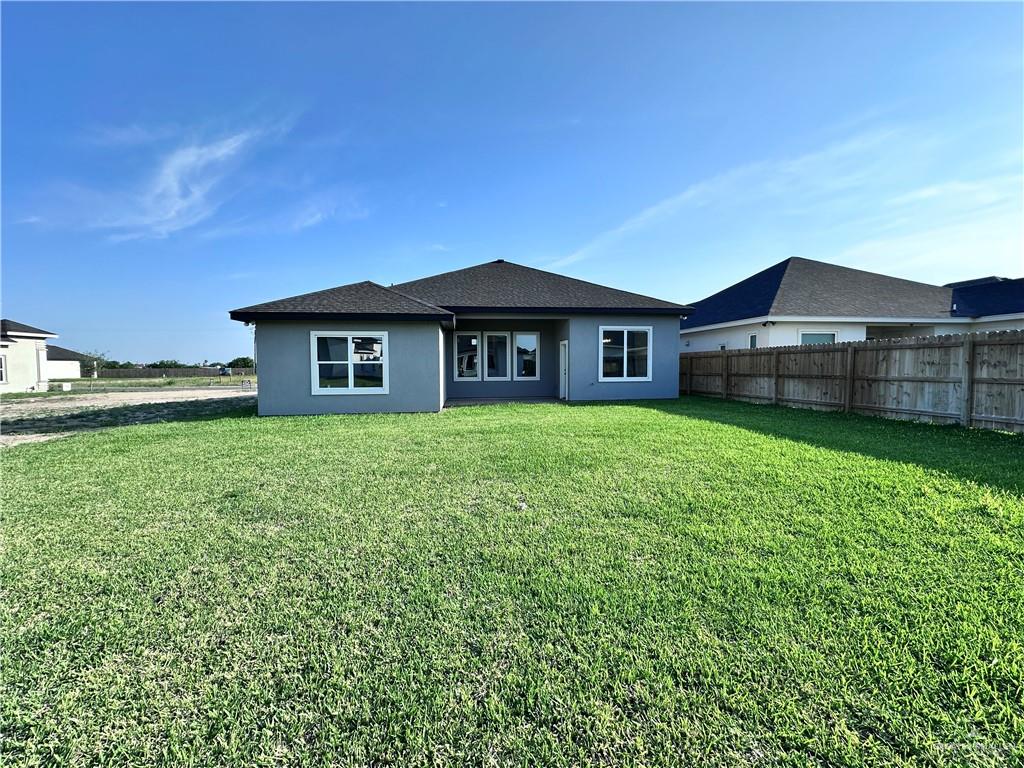 1100 Azalea Street Mission, TX 78573 - Photo 23 of 24 a front view of a house with garden