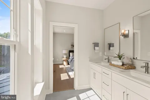 a bathroom with a double vanity sink and a mirror