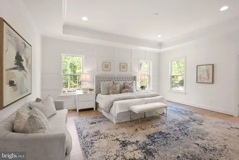 a spacious bedroom with a bed and a couch