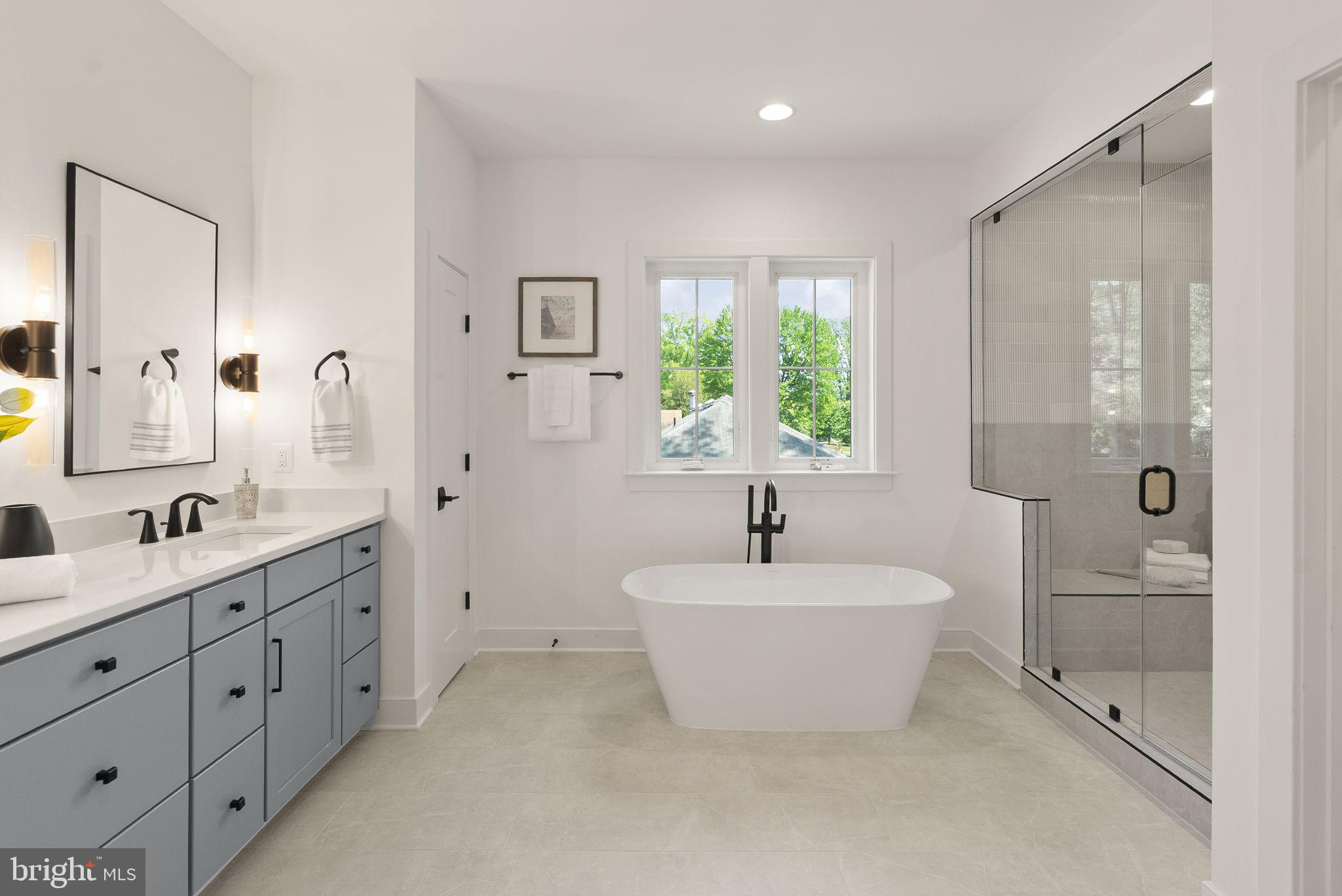 7215 Barnett Road Bethesda, MD 20817 - Photo 24 of 39 a spacious bathroom with a double vanity sink a mirror and a bathtub