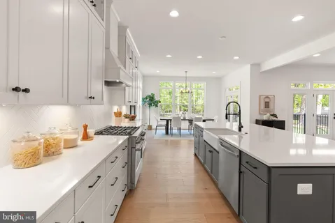 a large kitchen with stainless steel appliances lots of counter space and a sink