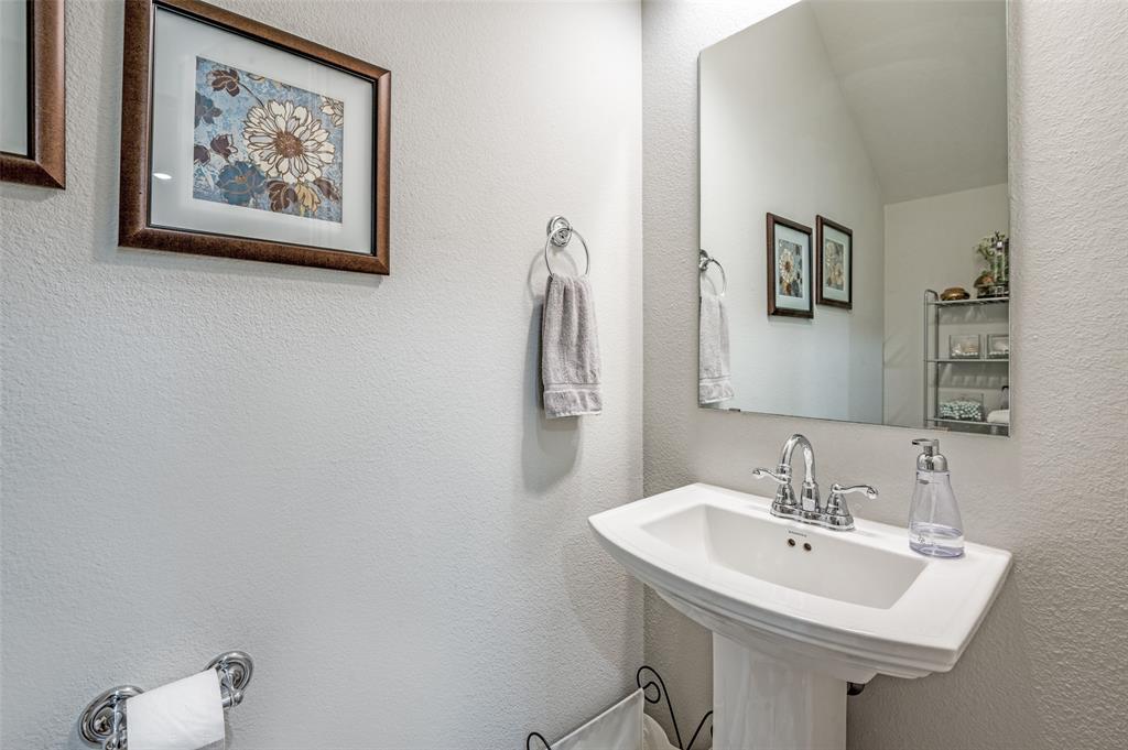 1560 Windermere Way Dallas, TX 75234 - Photo 12 of 25 Bathroom with a textured wall and a sink