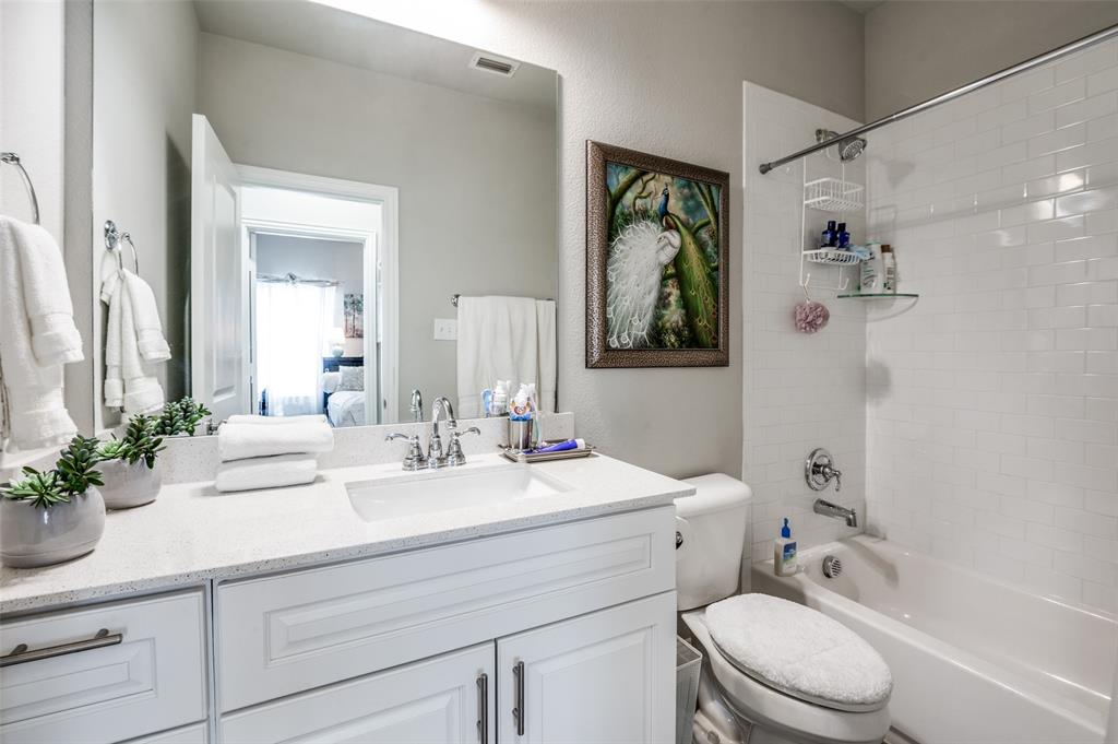 1560 Windermere Way Dallas, TX 75234 - Photo 18 of 25 Ensuite bathroom with vanity, shower / bath combination, and a textured wall