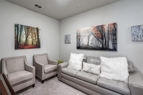 a living room with furniture a couch and painting on the wall