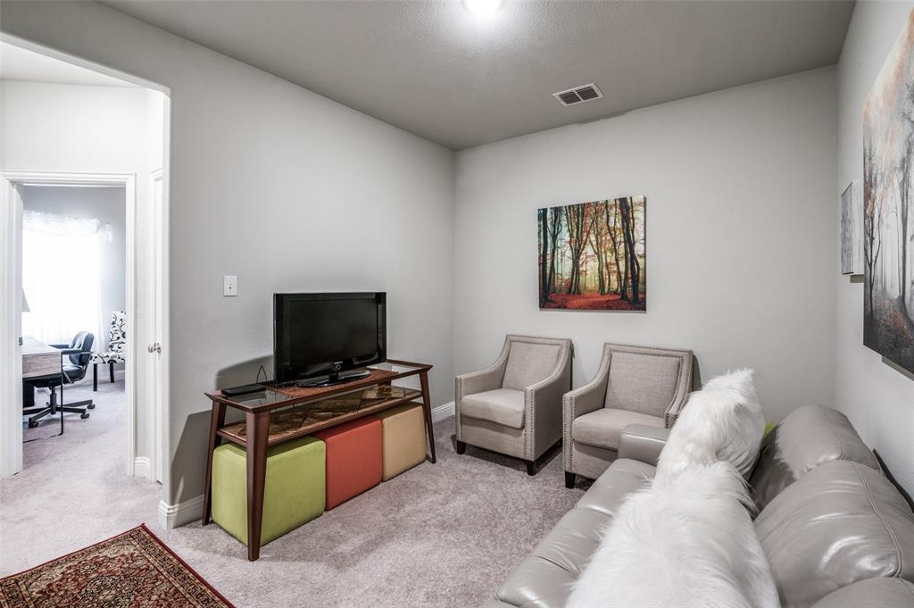 1560 Windermere Way Dallas, TX 75234 - Photo 22 of 25 Living room with light colored carpet and baseboards