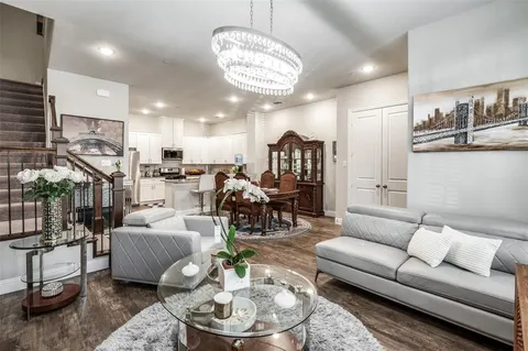 a living room with furniture and a chandelier
