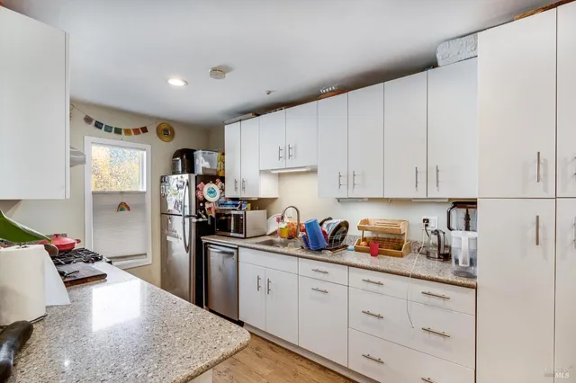 a bathroom with a sink vanity and toilet