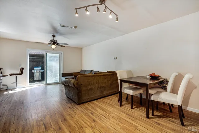 a kitchen with stainless steel appliances granite countertop a sink dishwasher and cabinets with wooden floor
