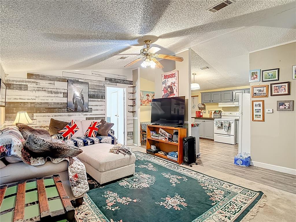 6421 Sunnyside Ranch Road Brooksville, FL 34602 - Photo 13 of 49 a living room with furniture and a flat screen tv