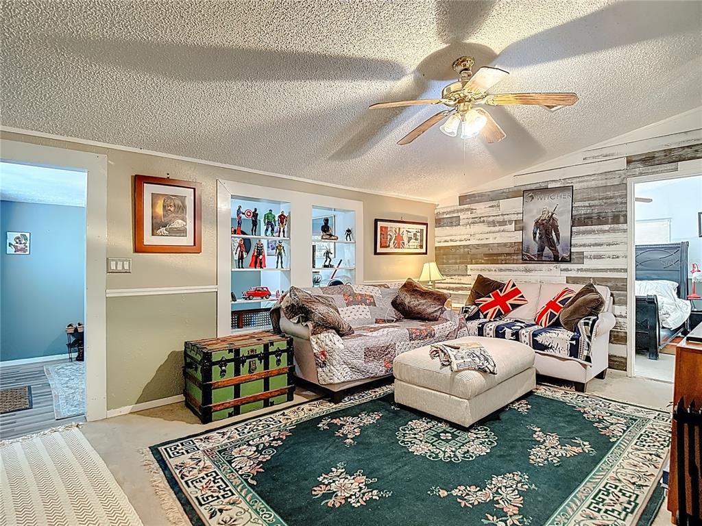 6421 Sunnyside Ranch Road Brooksville, FL 34602 - Photo 14 of 49 a living room with furniture and a rug