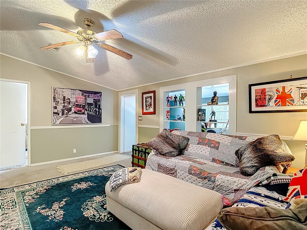 6421 Sunnyside Ranch Road Brooksville, FL 34602 - Photo 15 of 49 a bedroom with a bed and ceiling fan