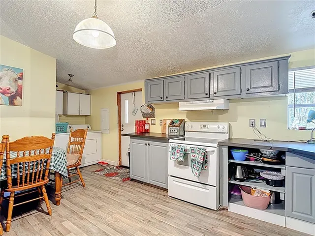 a kitchen with stainless steel appliances granite countertop a stove and cabinets