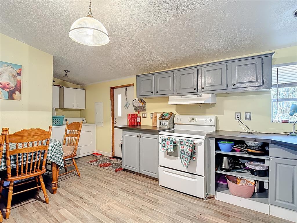 6421 Sunnyside Ranch Road Brooksville, FL 34602 - Photo 18 of 49 a kitchen with stainless steel appliances granite countertop a stove and cabinets