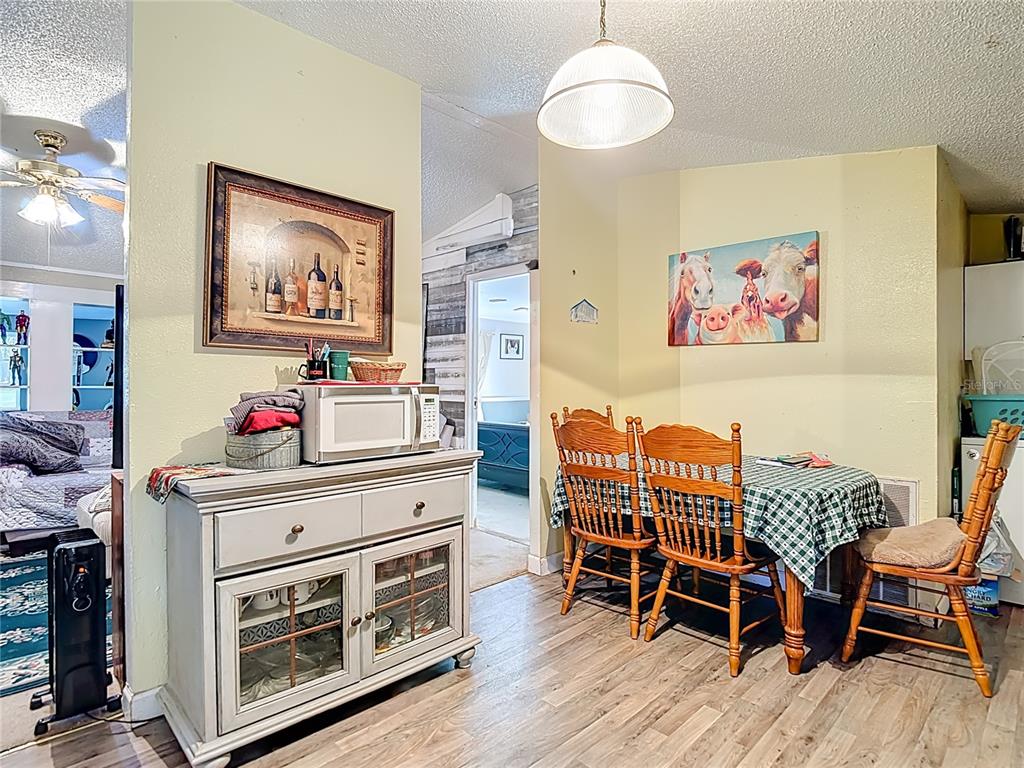 6421 Sunnyside Ranch Road Brooksville, FL 34602 - Photo 22 of 49 a view of a dining room with furniture and wooden floor