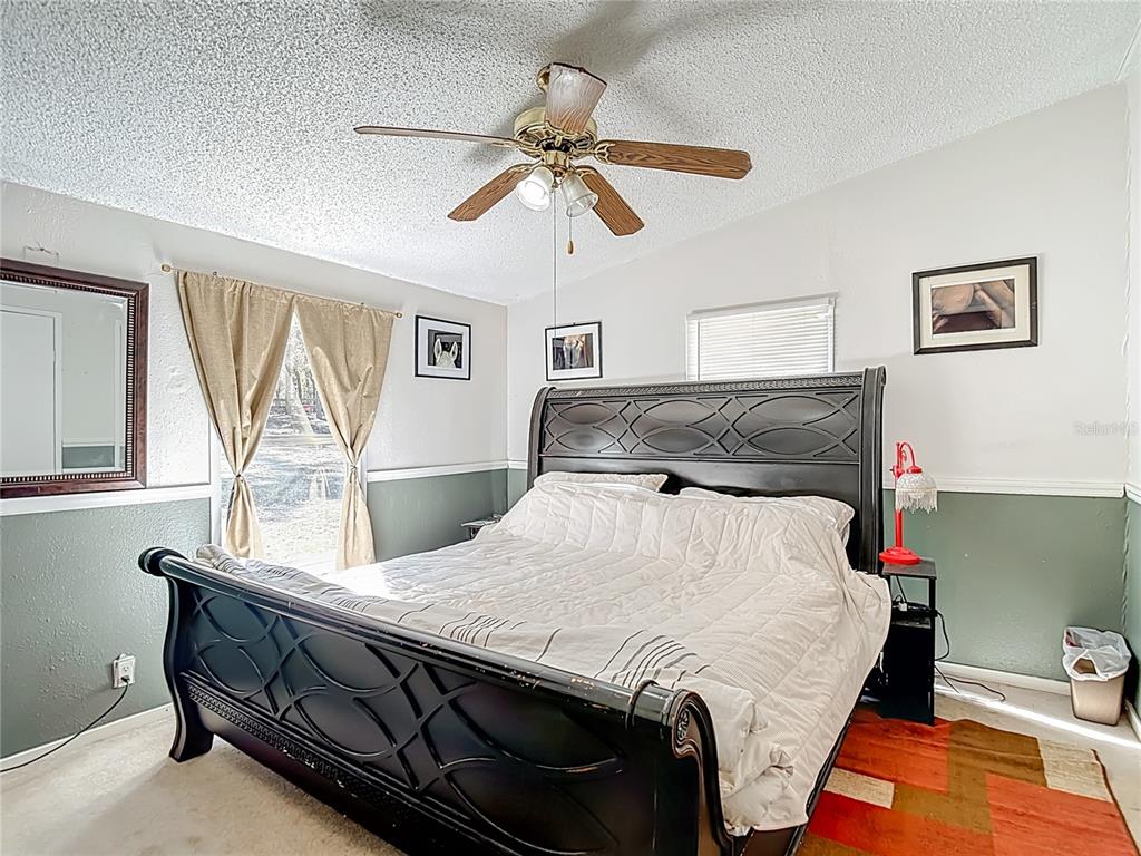 6421 Sunnyside Ranch Road Brooksville, FL 34602 - Photo 27 of 49 a bedroom with a bed a dresser and window