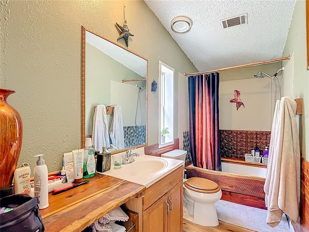 6421 Sunnyside Ranch Road Brooksville, FL 34602 - Photo 29 of 49 a bathroom with a sink vanity mirror and toilet