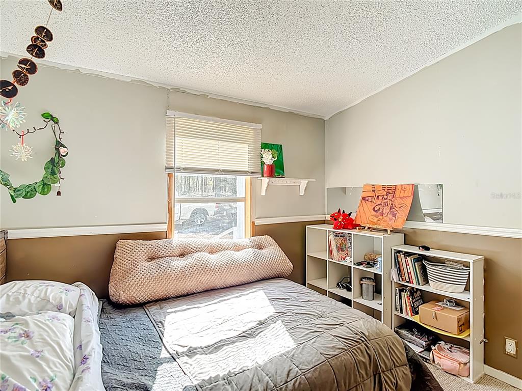 6421 Sunnyside Ranch Road Brooksville, FL 34602 - Photo 31 of 49 a bedroom with a bed and a window