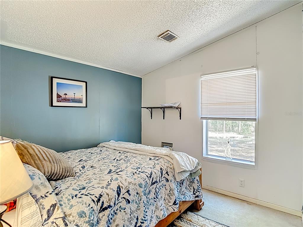 6421 Sunnyside Ranch Road Brooksville, FL 34602 - Photo 34 of 49 a bedroom with a bed and a window