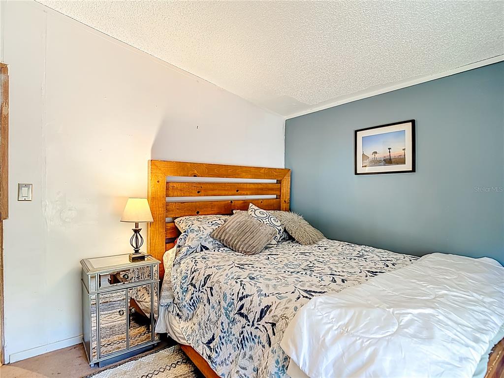 6421 Sunnyside Ranch Road Brooksville, FL 34602 - Photo 35 of 49 a bedroom with a bed and wooden floor