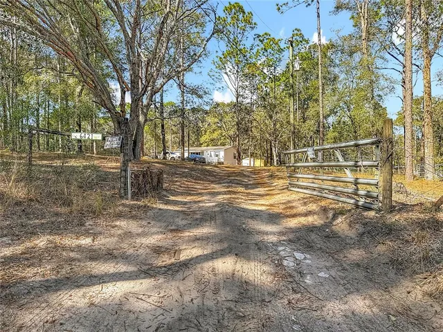 a backyard of a house with large trees