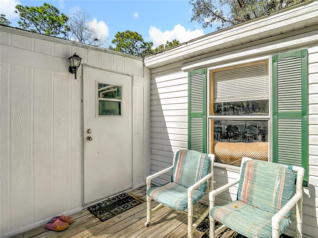 6421 Sunnyside Ranch Road Brooksville, FL 34602 - Photo 5 of 49 a view of a chair and table in the balcony