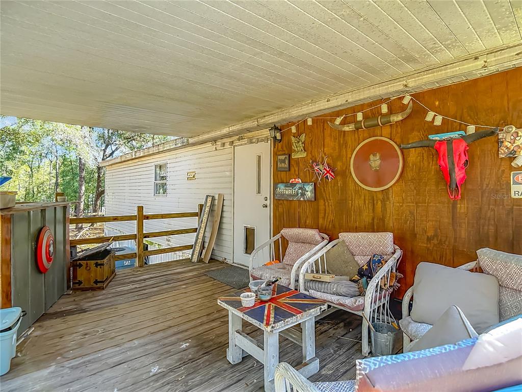 6421 Sunnyside Ranch Road Brooksville, FL 34602 - Photo 8 of 49 a patio with table and chairs