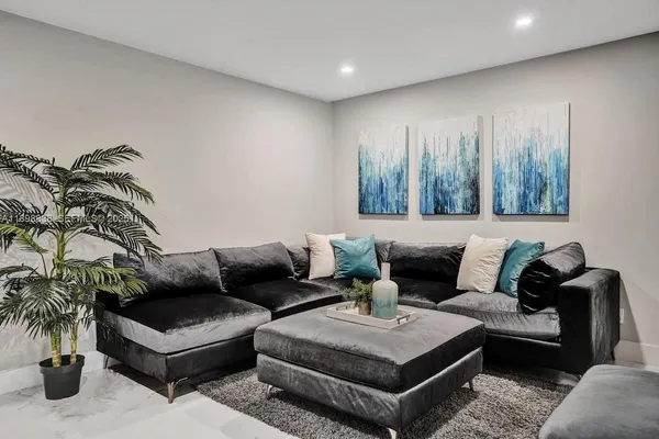 a living room with furniture and a potted plant