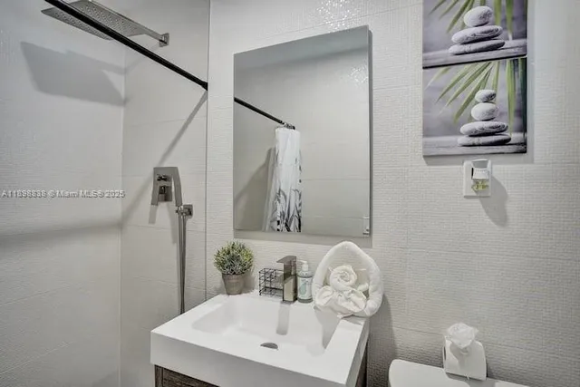 a bathroom with a sink vanity and mirror