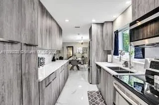 a kitchen with stainless steel appliances sink stove microwave and cabinets