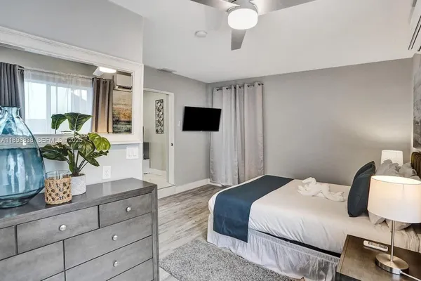 a bedroom with a bed and a potted plant