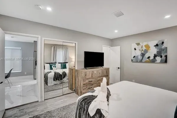 a bedroom with a bed and a flat screen tv