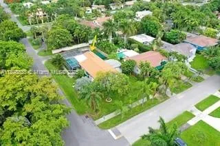 an aerial view of residential house with outdoor space and trees all around