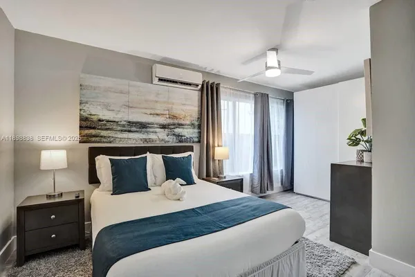 a bedroom with a bed and a night stand
