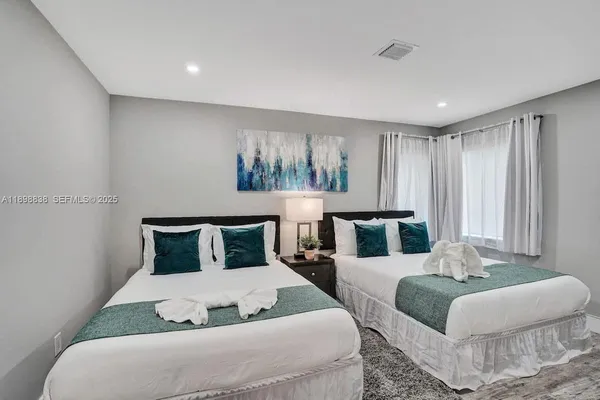 a bedroom with furniture and a large window